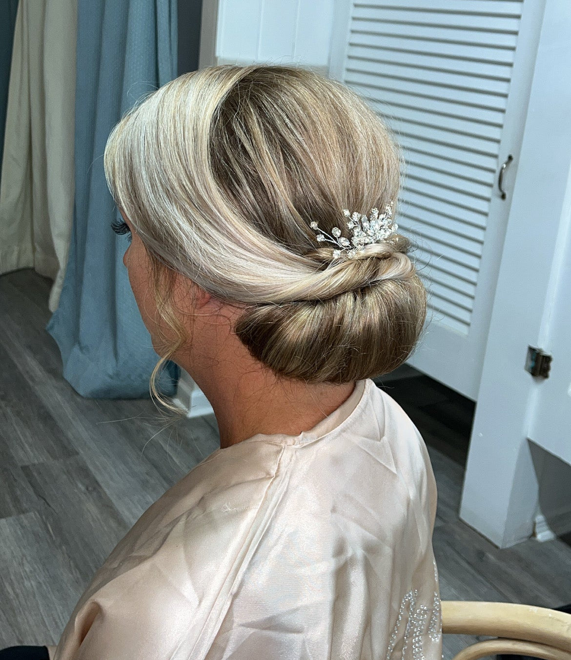 Elegant blonde bridal chignon bun with pearl hair accessory for Florida bride by Glow & Go Beauty
