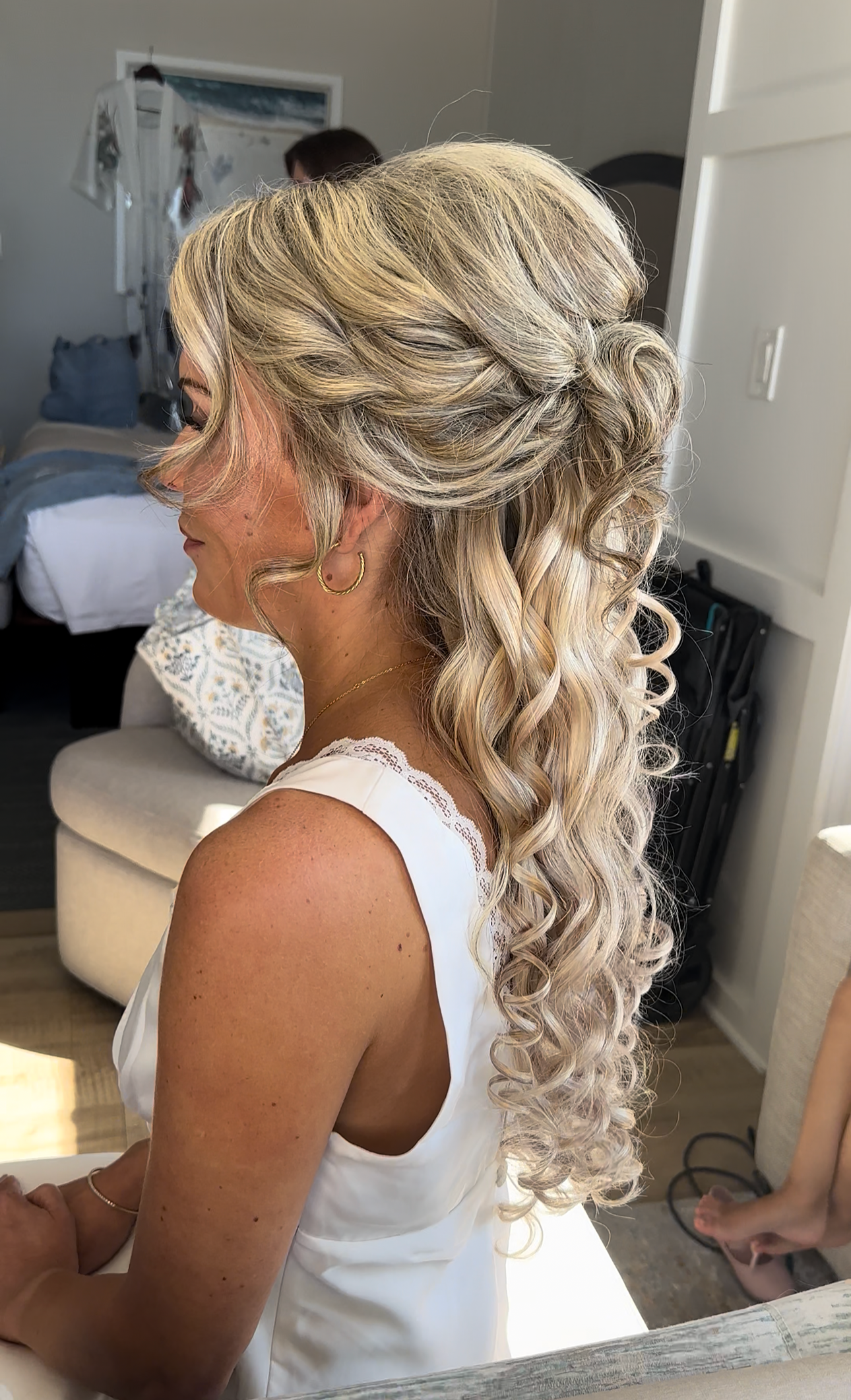 Half-up blonde bridal hairstyle with cascading curls for Florida bride by Glow & Go Beauty