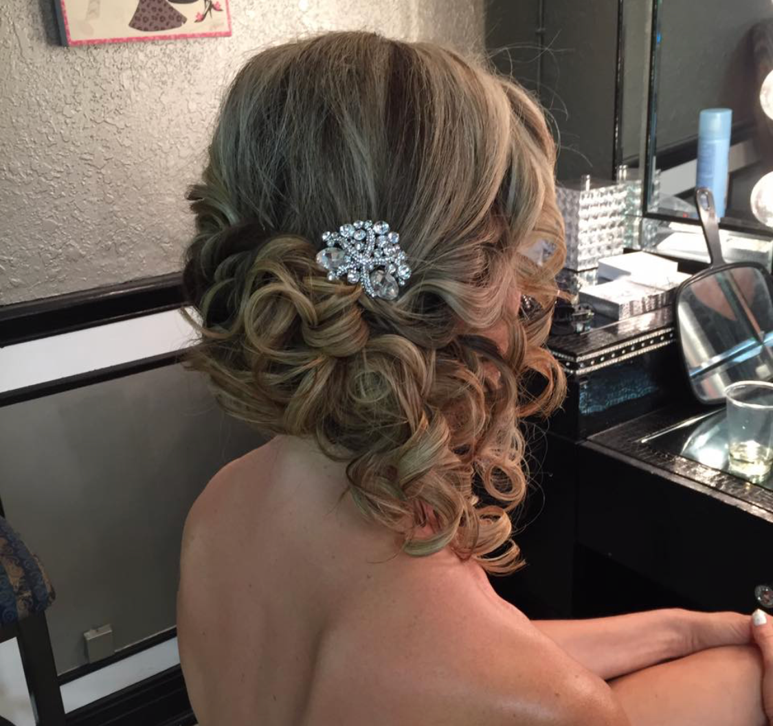 Romantic bridal updo with decorative hair accessory for Florida bride by Glow & Go Beauty