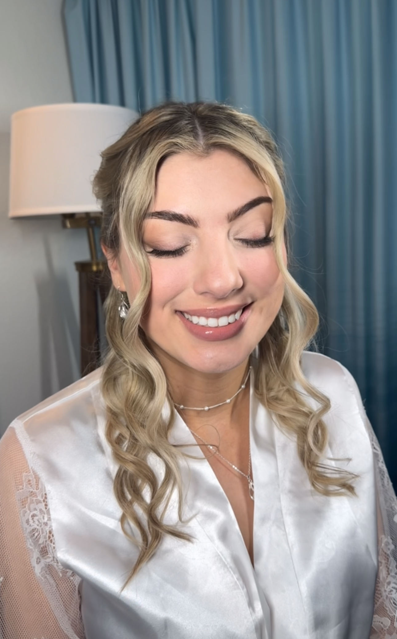 Close-up, eyes closed of Florida bride with soft glam makeup and loose bridal curls by Glow & Go Beauty