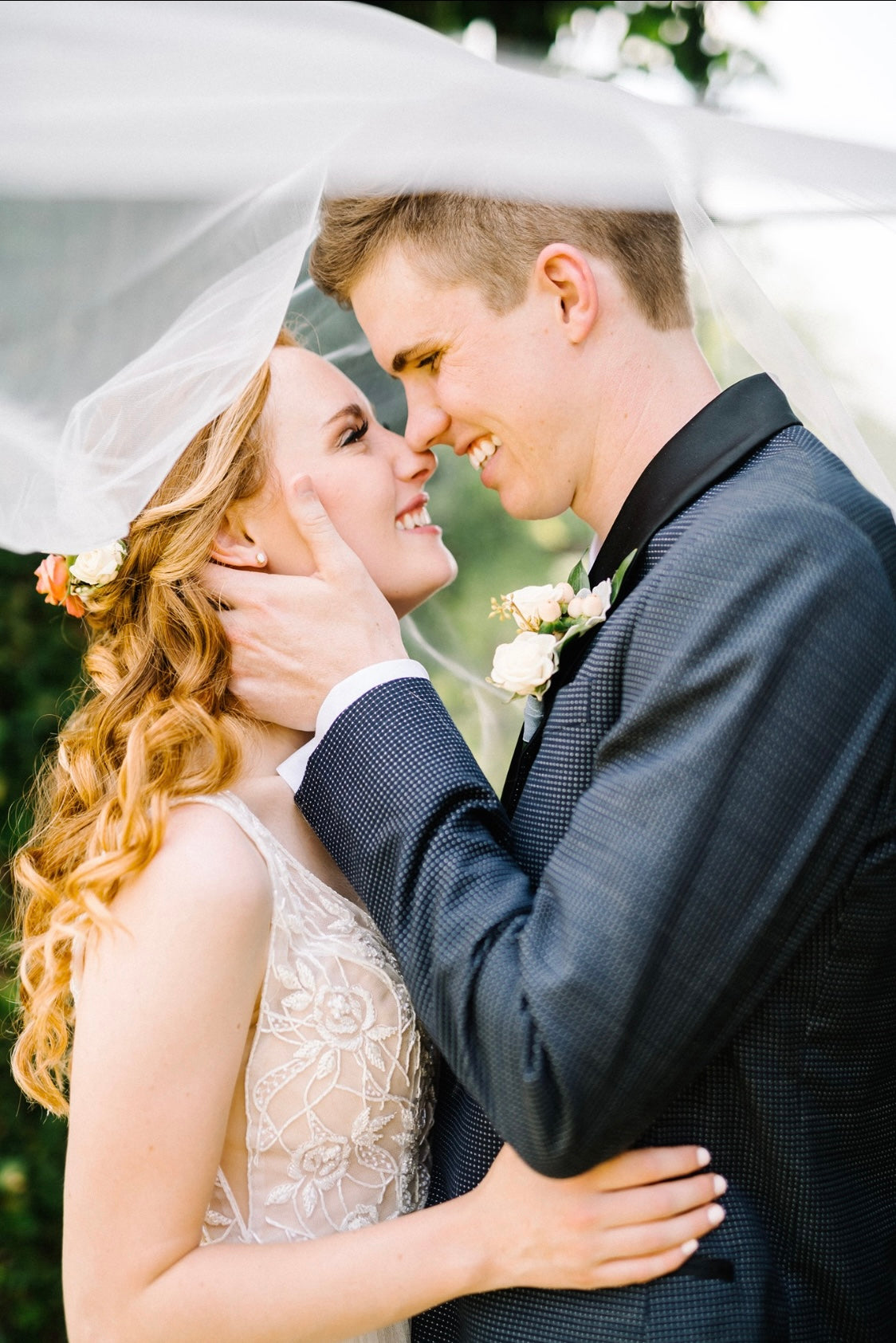 Romantic Florida bride and groom portrait under wedding veil by Glow & Go Beauty