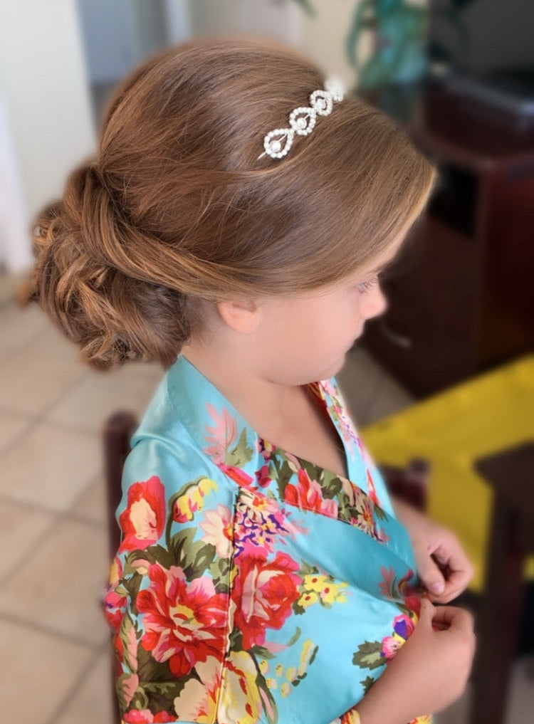 Flower girl bridal hairstyle with decorative tiara for Florida wedding by Glow & Go Beauty